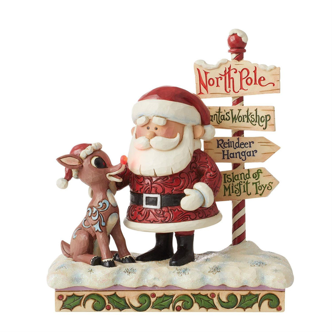 Rudolph and Santa Next to North Pole Sign